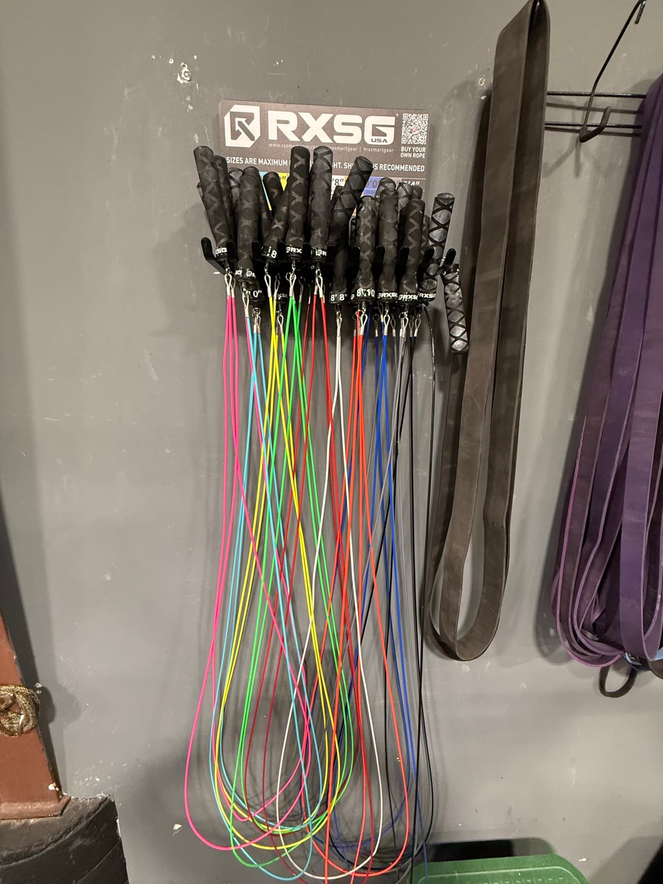 Jump ropes and bands on the wall of the gym