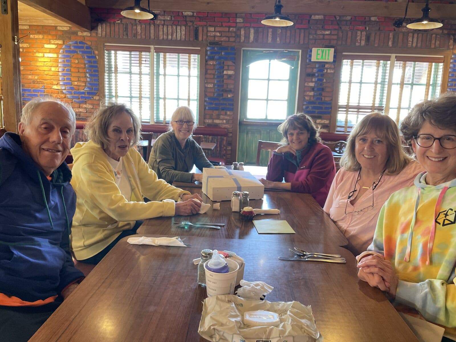 Members laughing around a lunch table