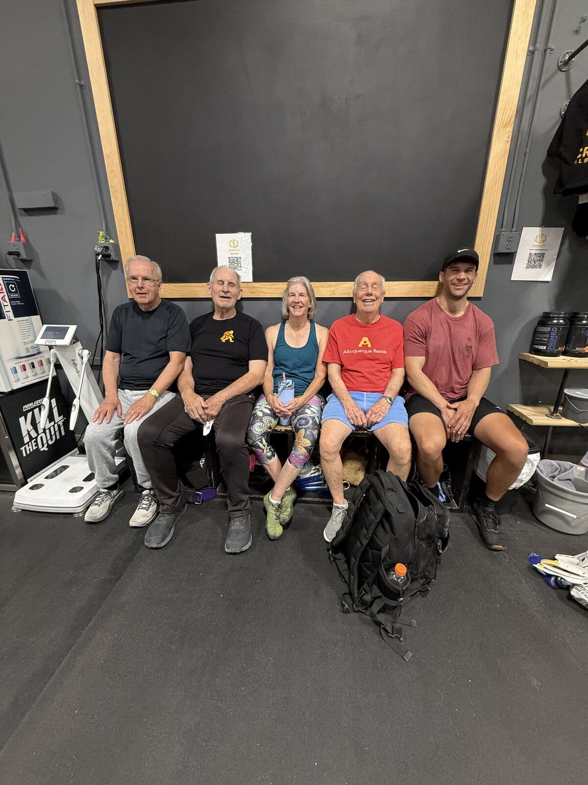 Six Fit for Life members on a bench in the gym