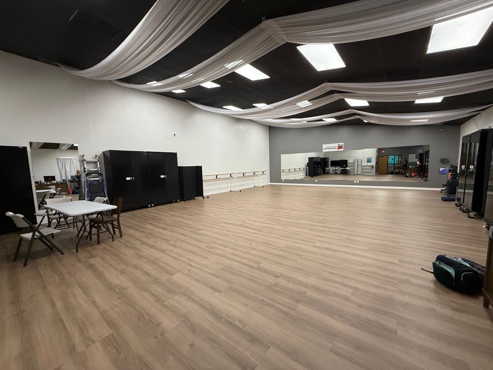 The event room at CrossFit Albuquerque, open floor with mirrors and a draped ceiling
