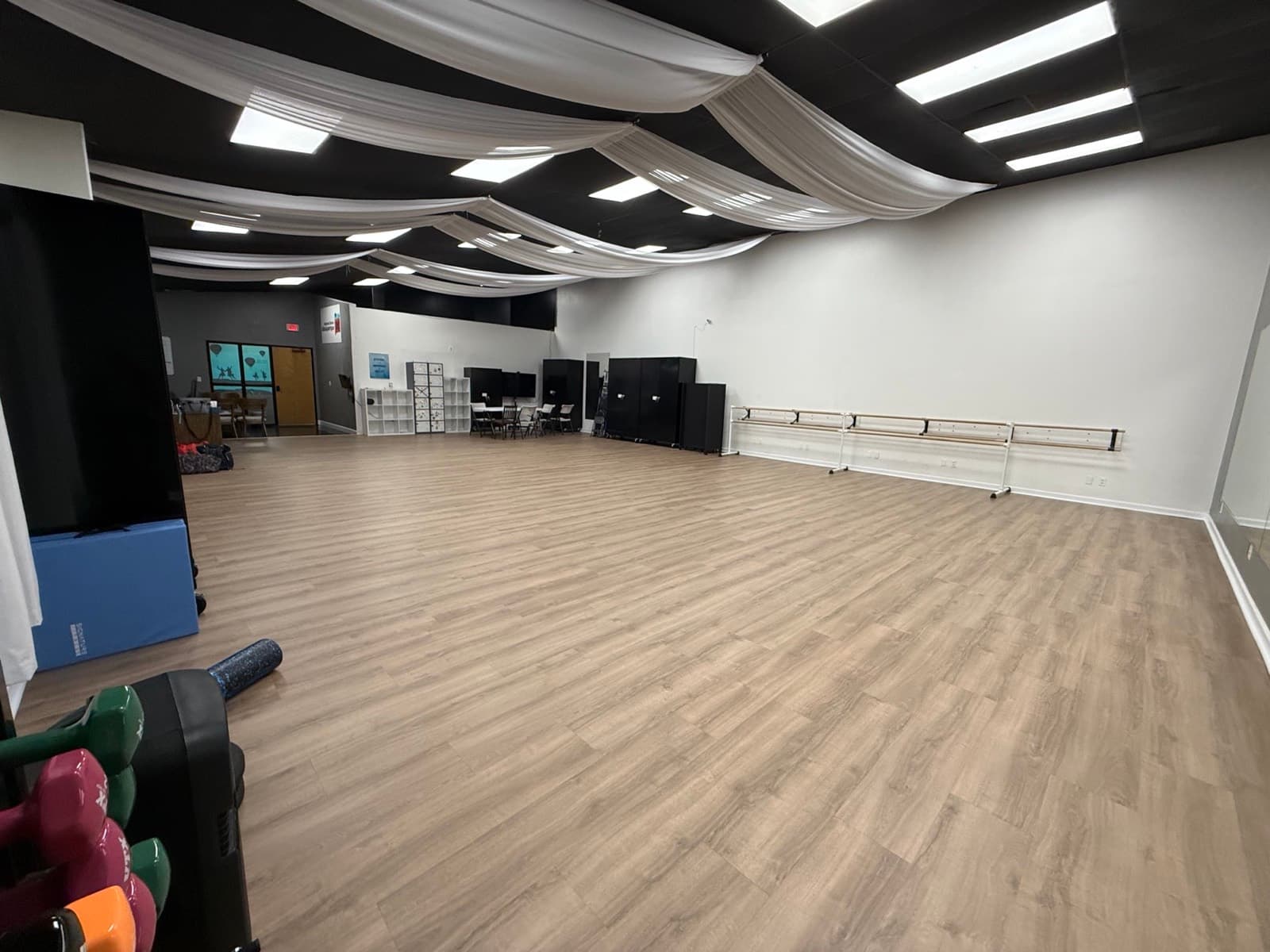 The event room from the doorway, wood floor and mirrored wall
